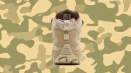 Image of the heel of the Merrell Moab 3 Camo Mid Waterproof shown head on. It's positioned against a desert camo patterned background.