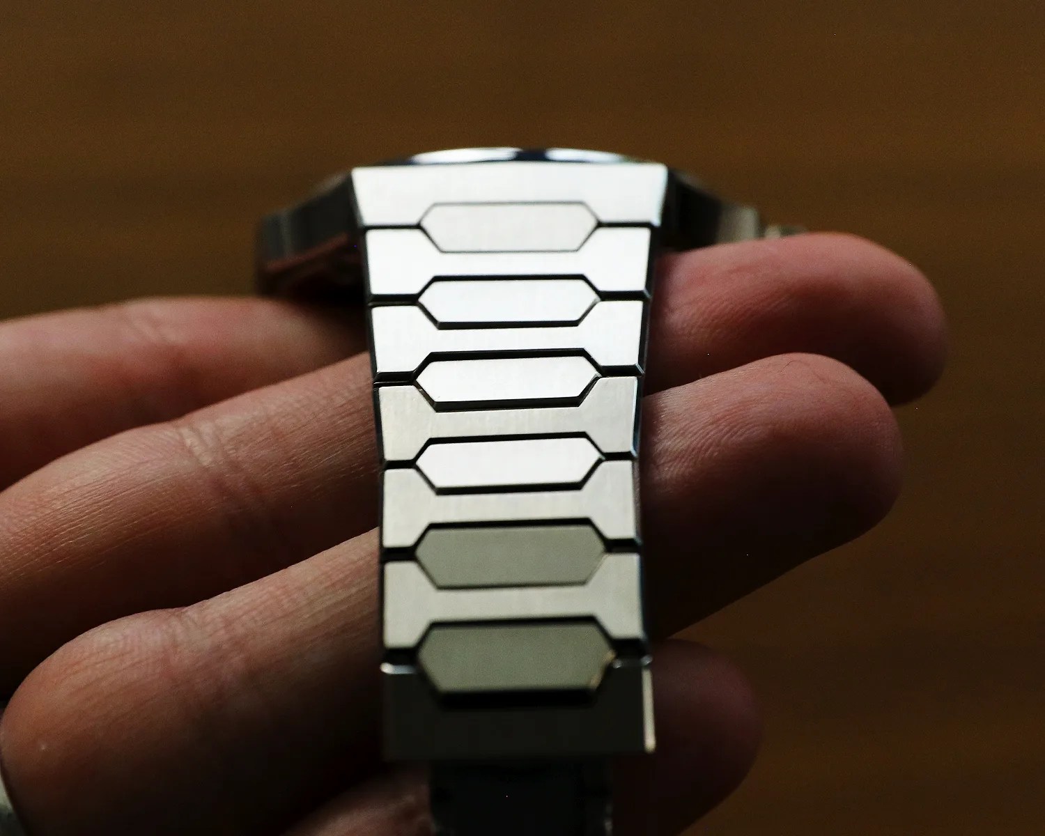 atelier wen watch bracelet held in a hand
