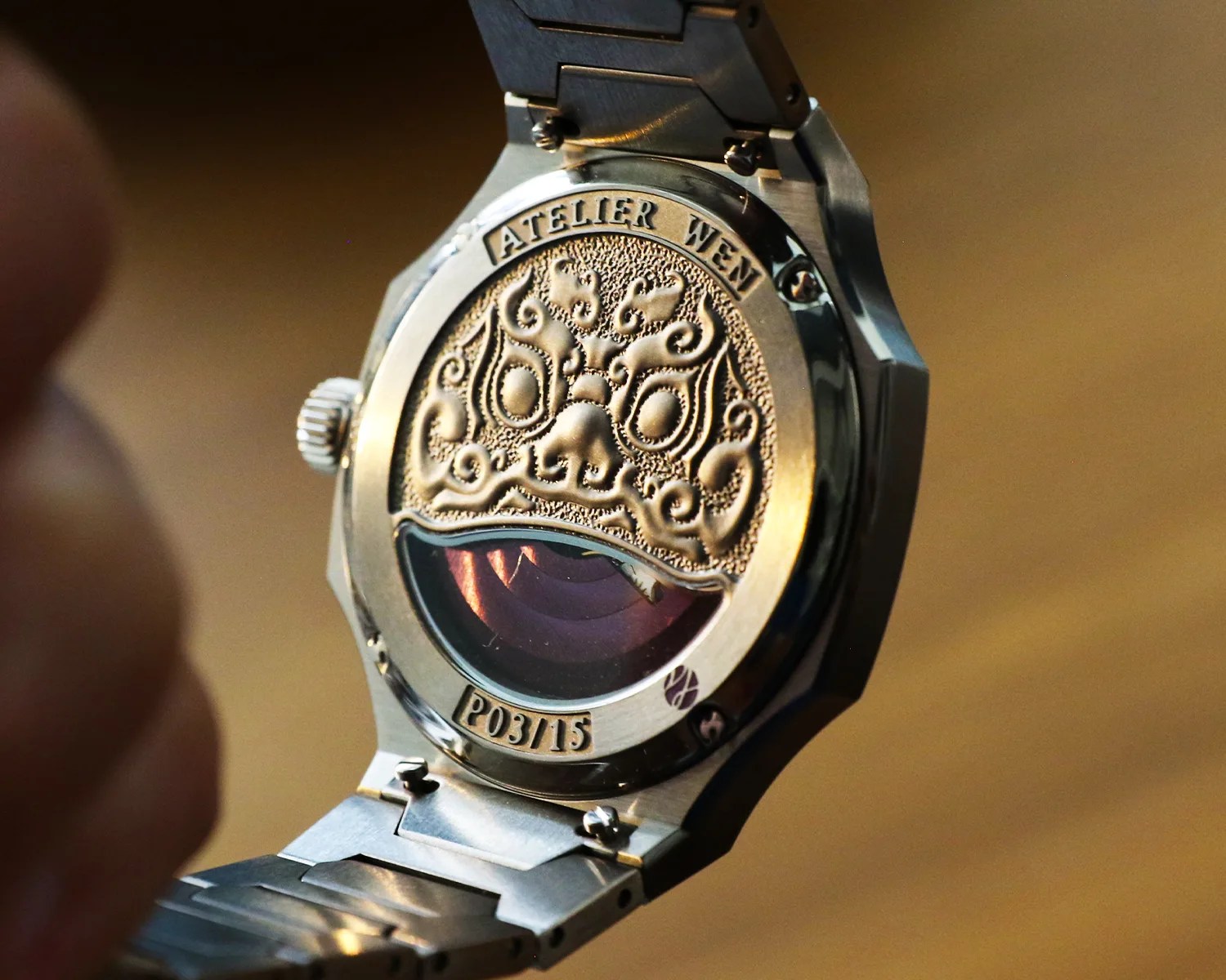 the caseback of an atelier wen watch depicting a lion