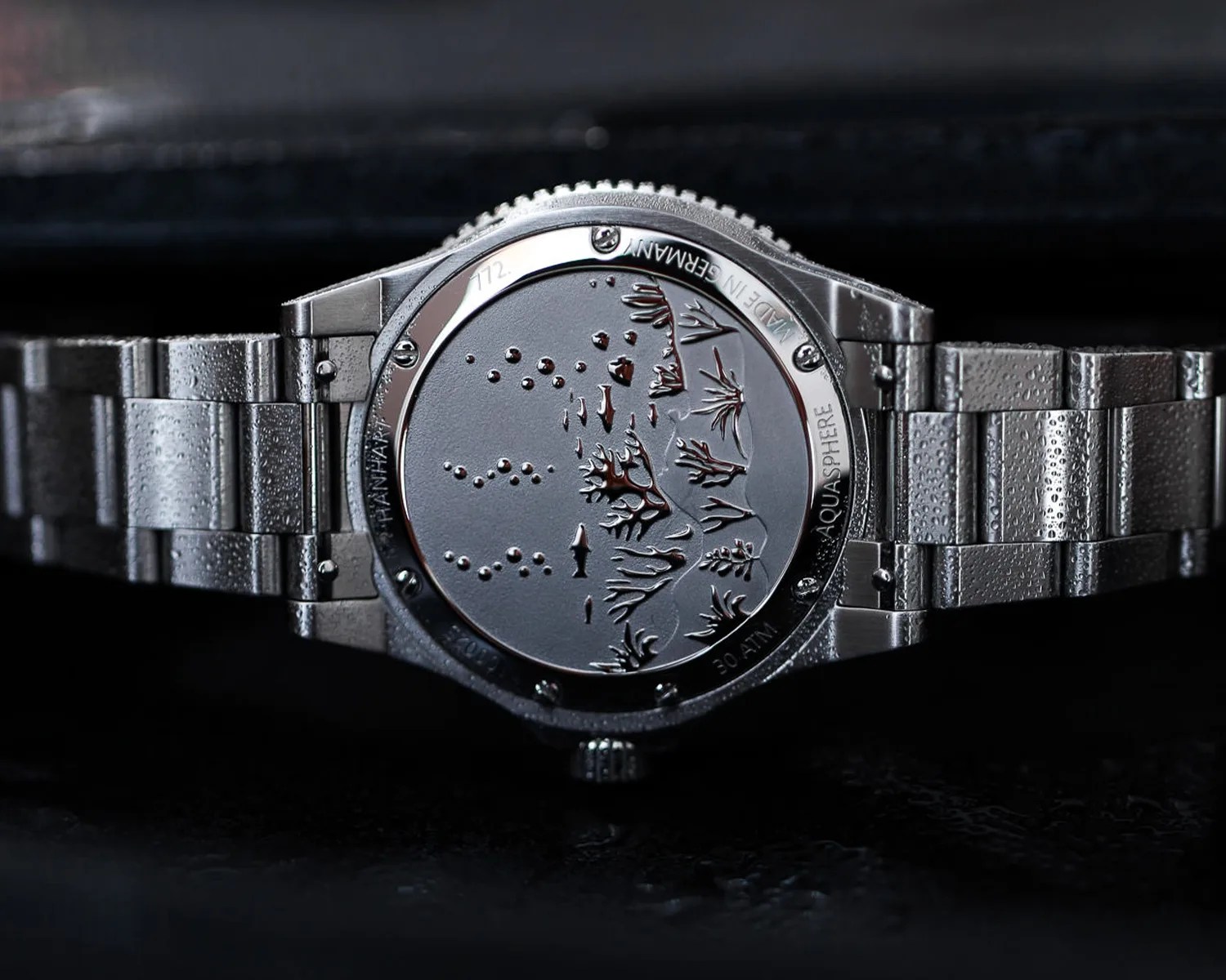 the caseback of a hanhart dive watch depicting an ocean scene