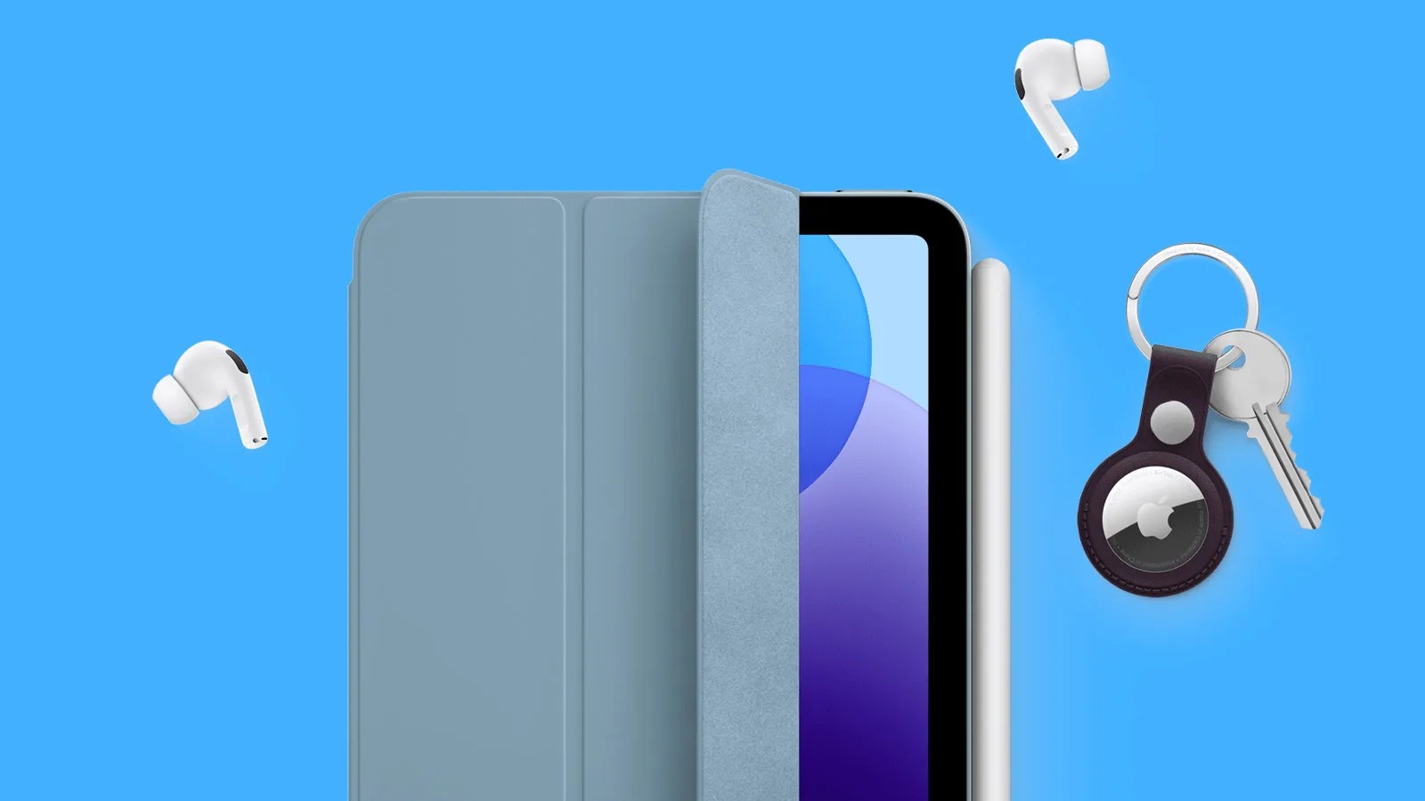 iPad Mini 7th generation shown with Apple's Smart Silicon cover slightly unrolled to reveal a small silver of the right hand side of the screen. An Apple Pencil is attached to the right hand side of the tablet and a pair of Airpods Pro and an set of keys with an AirTag holder are scatted around the tablet. It also shown against a bright blue background.