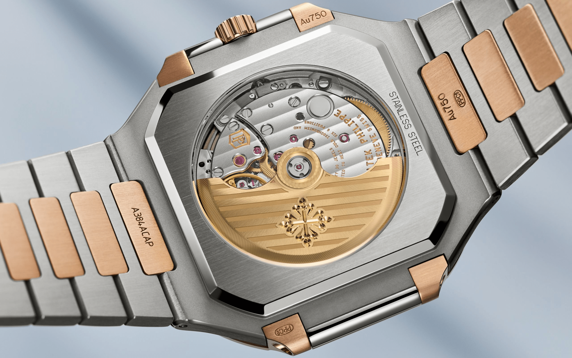 The back of the Patek Philippe 5821/1AR Cubitus shown suspended flat at an angle to highlight the movement and drape of the watch bracelet