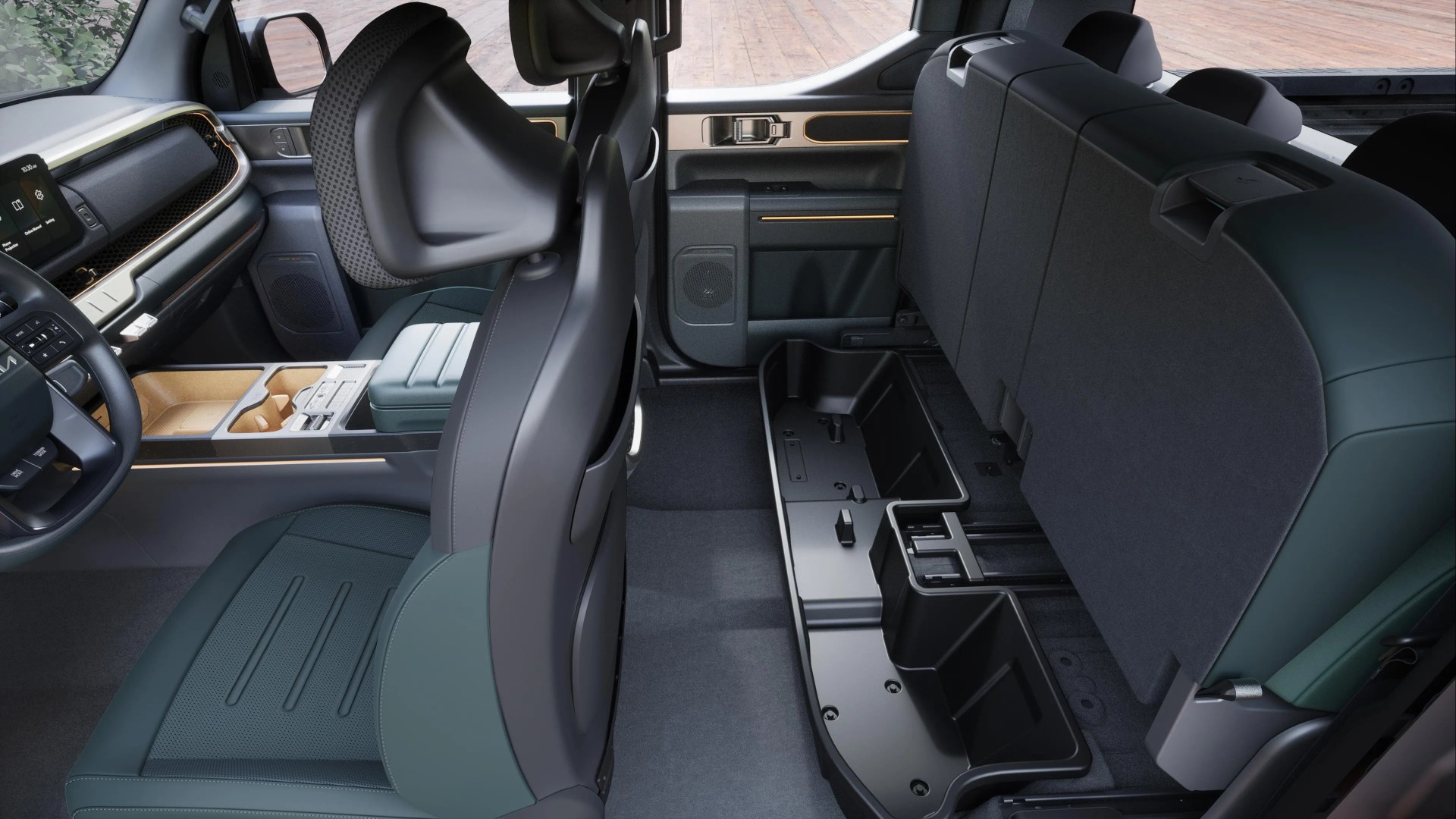 Image taken from the side of the interior of the Kia Tasman showing how the back seats lift up to show internal cubby storage below. 