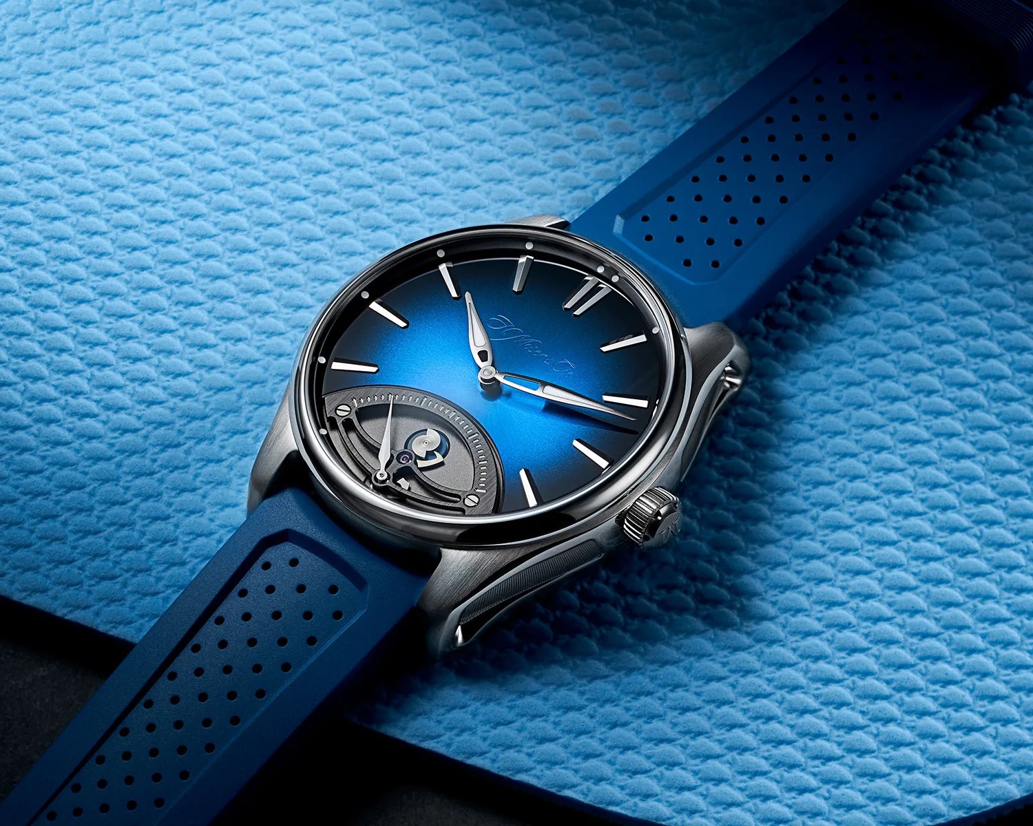 moser watch on a blue surface