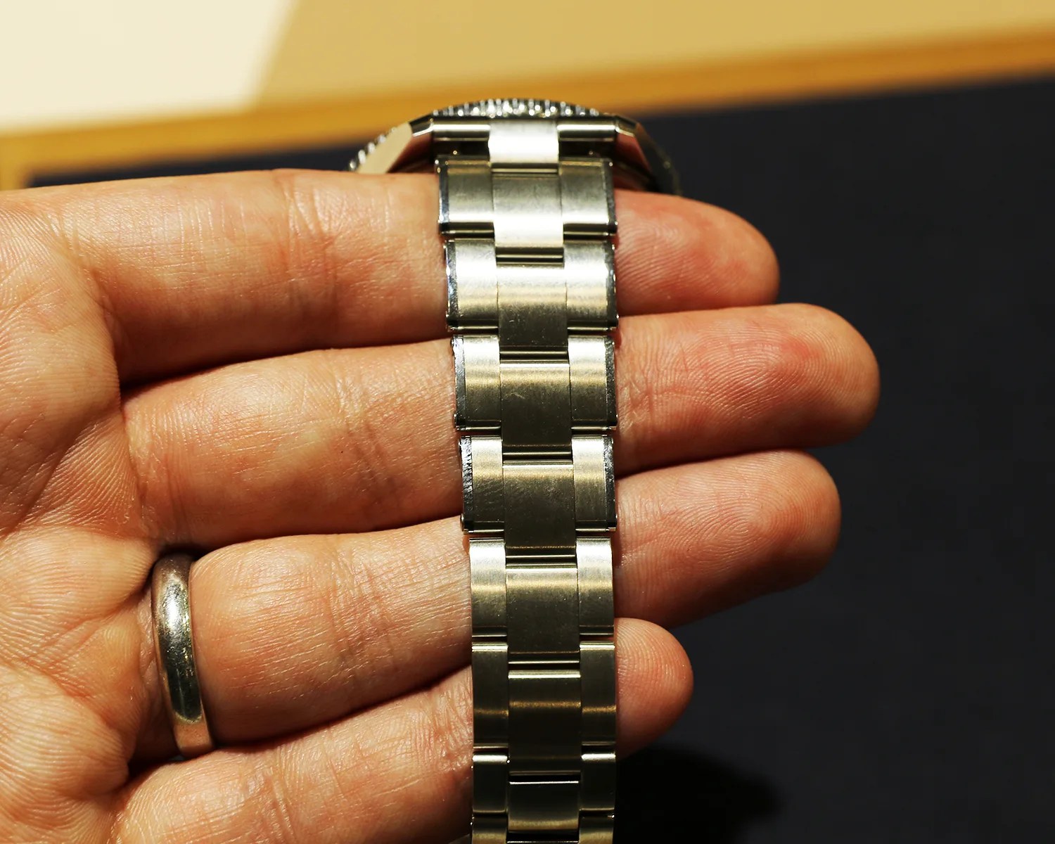 a hand holding an oris watch bracelet