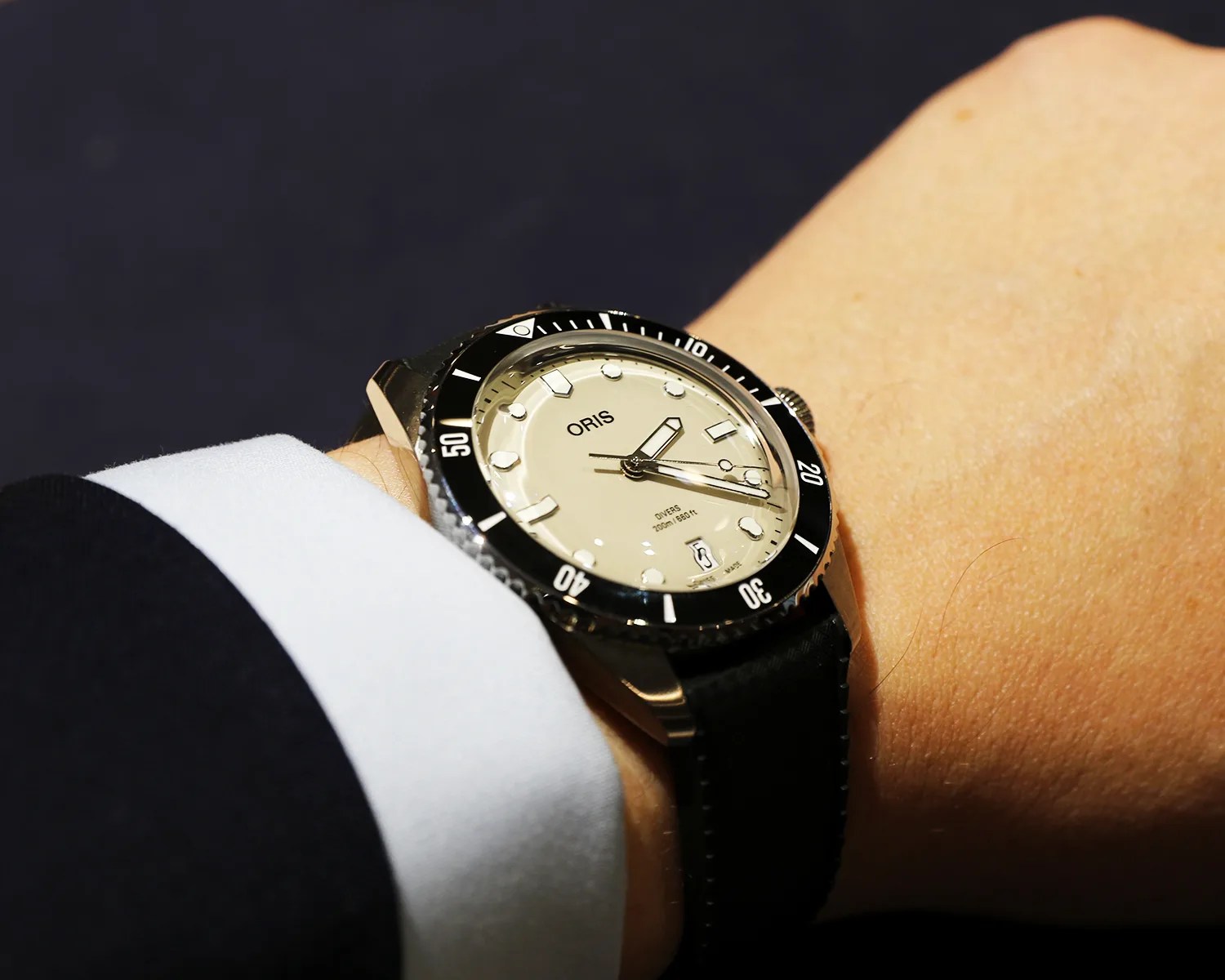 an oris dive watch on a mans wrist