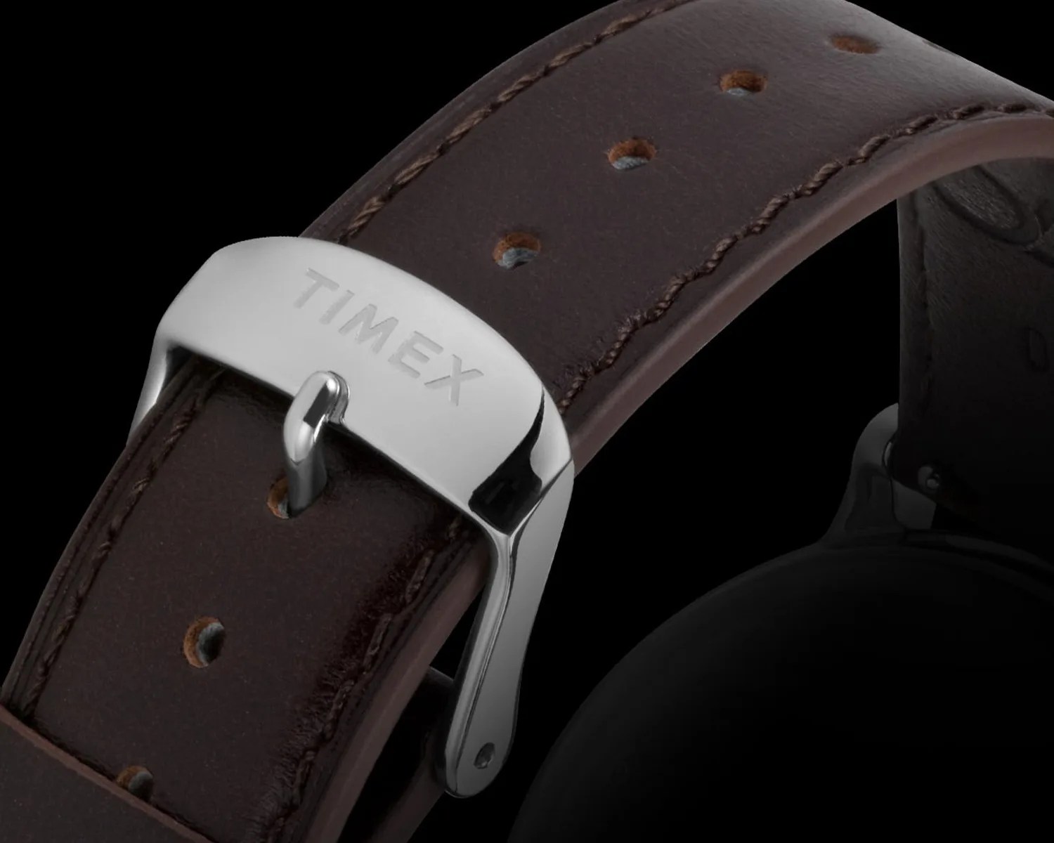 a closeup of a timex buckle on a brown leather watch strap