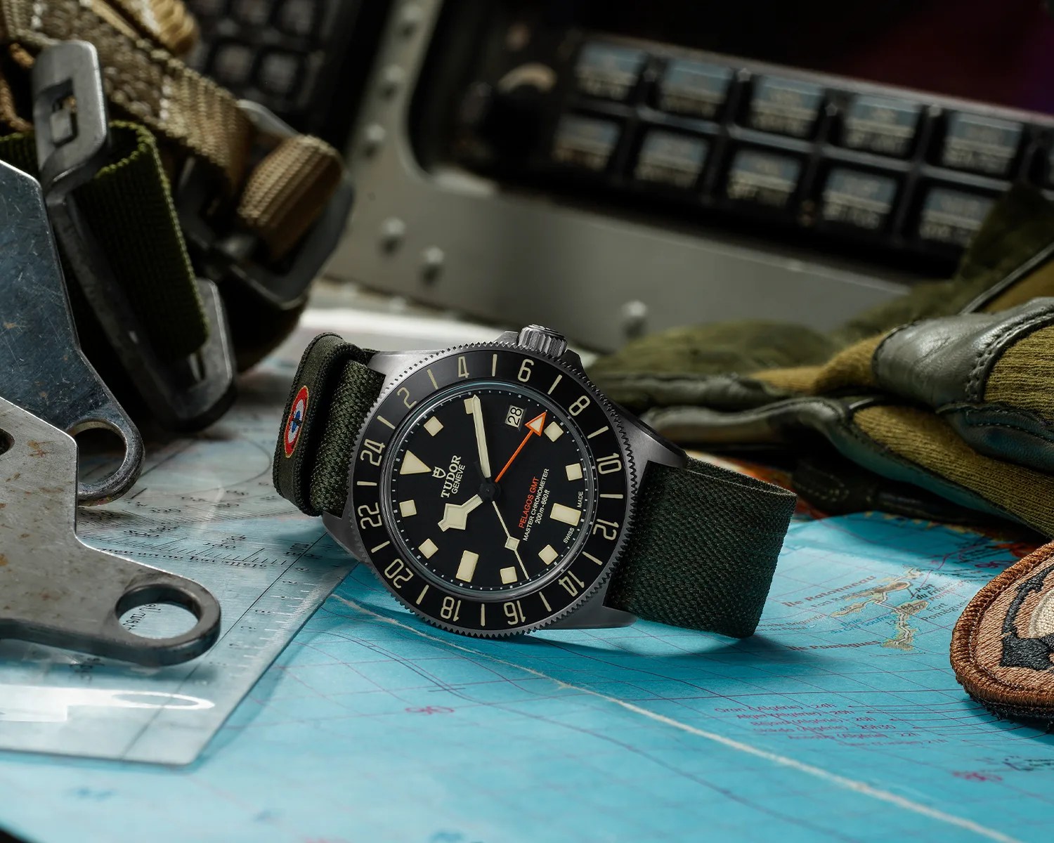 a tudor pelagos gmt tool watch on a map
