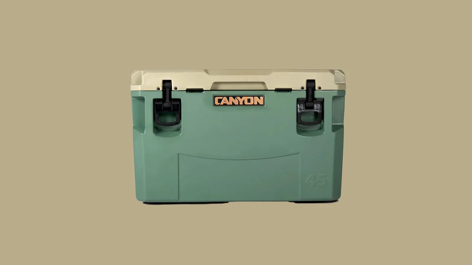 A Canyon PRO 45 Quart Cooler sitting closed facing forward on a tan background. The cooler features a light sand/tan colored lid and green colored body.