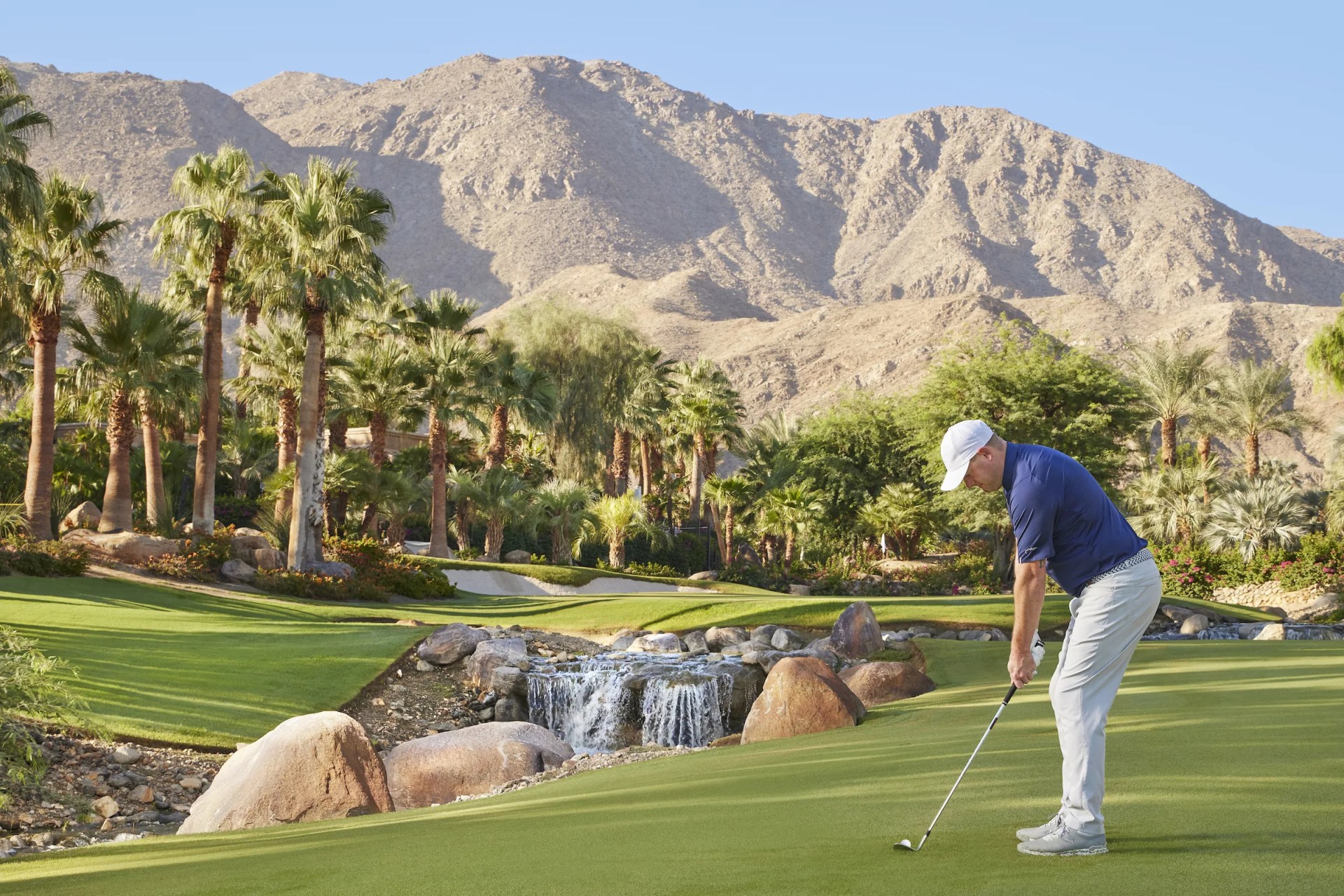 A man tees up in palm springs
