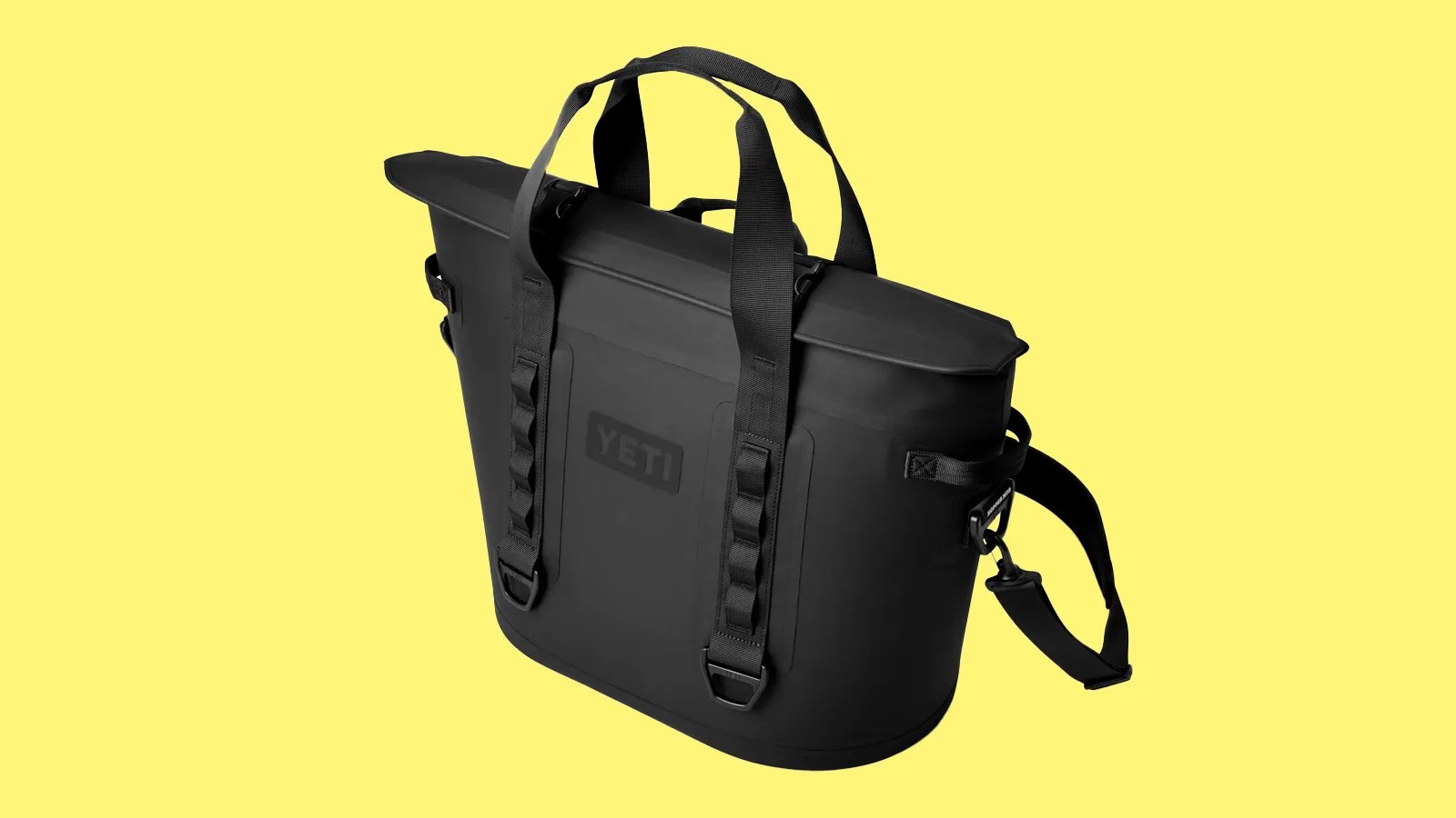 Yeti's hopper M30 Tote in black shown against a bright yellow background