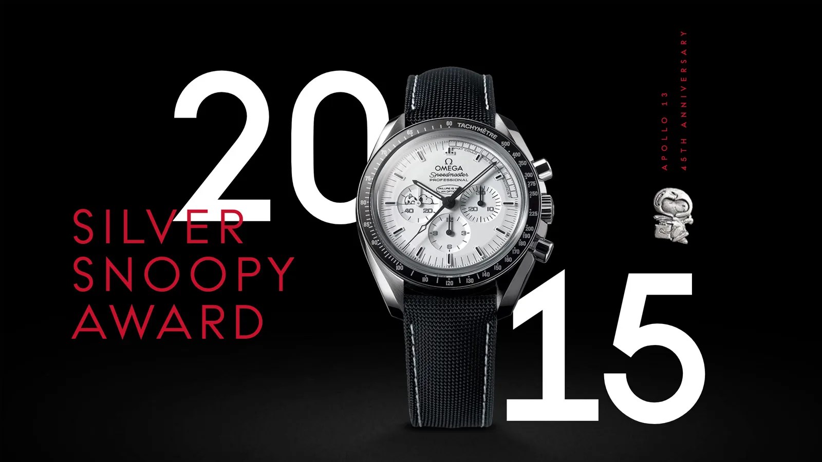 A graphic highlighting the launch of the Omega Silver Snoopy Award Watch in 2015. The graphic shows the year 2015 in white and the name Silver Snoopy Award in Red. The watch itself, an Omega Speedmaster with a white face and a black dial and black strap is also shown head on sitting between the 20 and 15 of the date. The entire background of the image is black.
