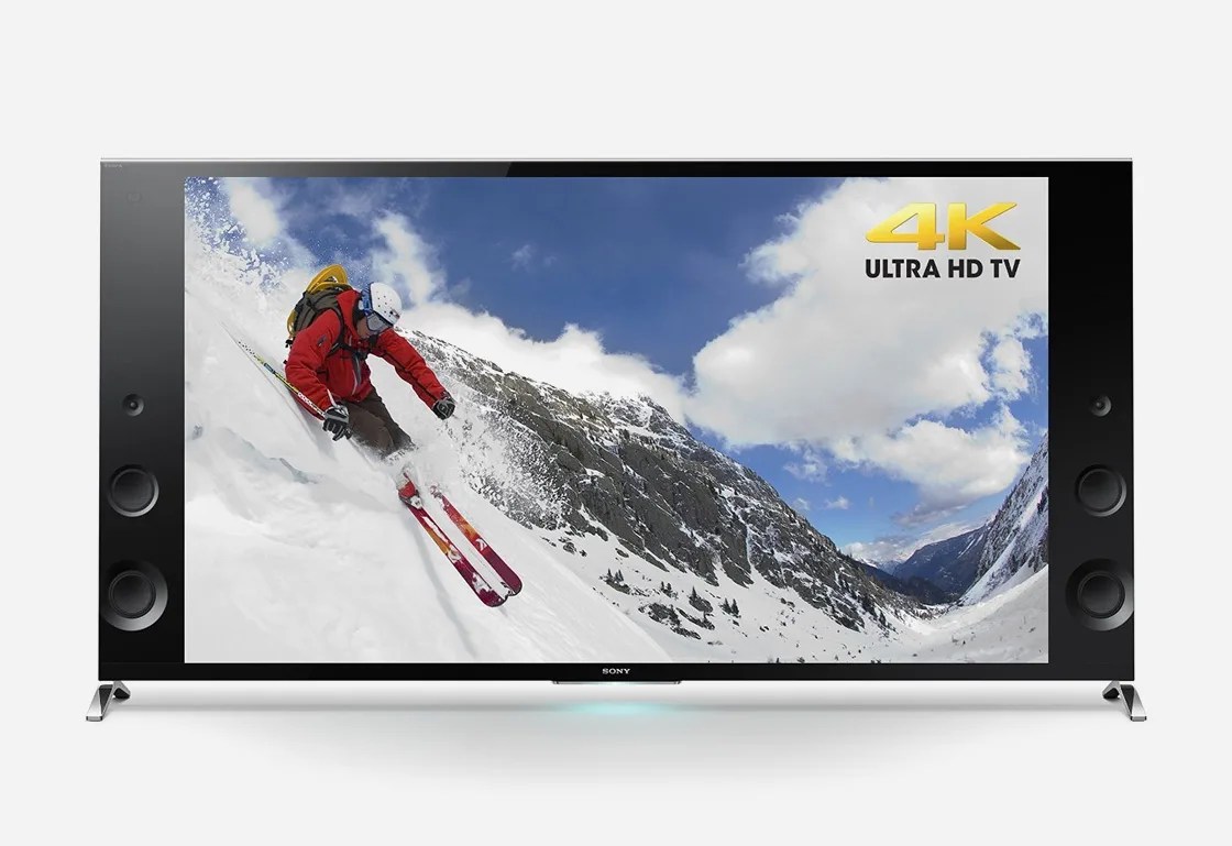 The 2014 Sony XBR-X900B shown against a light grey background. The screen depicts a skier going down the mountain. 
