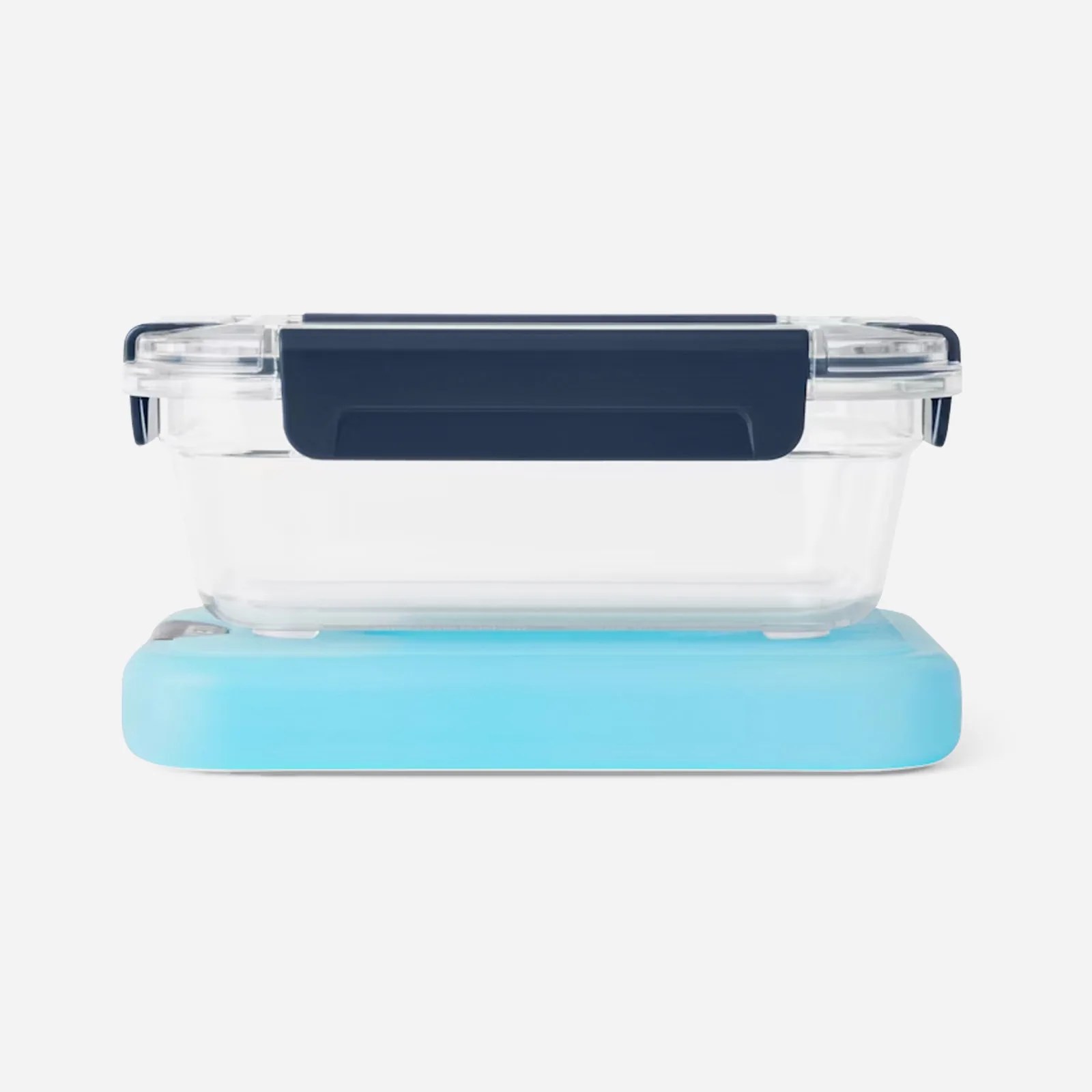 A Yeti Large clear food storage container shown sitting snuggly on a matching sized Yeti thin ice pack sitting under the container. The product is empty and shown on a grey backgroun. 