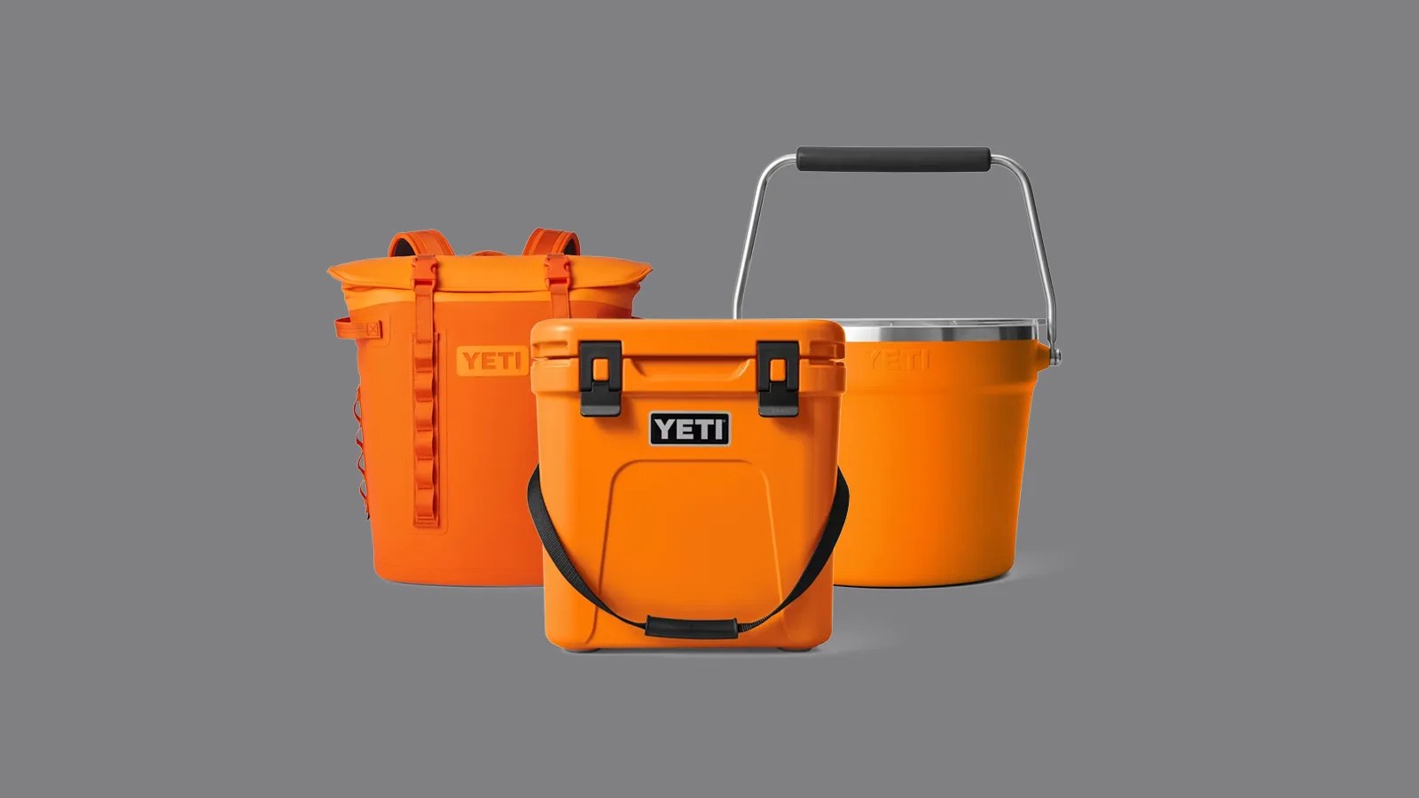 A Yeti cooler backpack, roadie cooler and ice bucket aligned next to each other in bright king crab orange. The product images are sitting against a dark grey background.