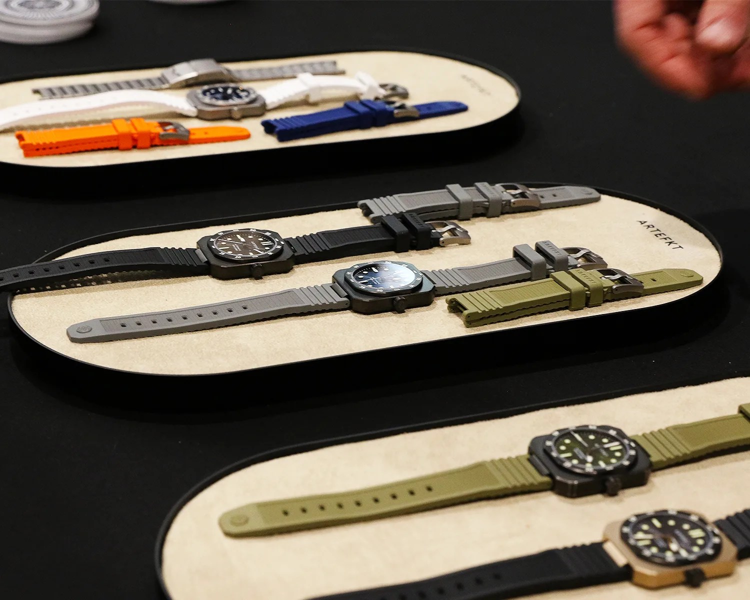 a row of Artefkt watches displayed on a table