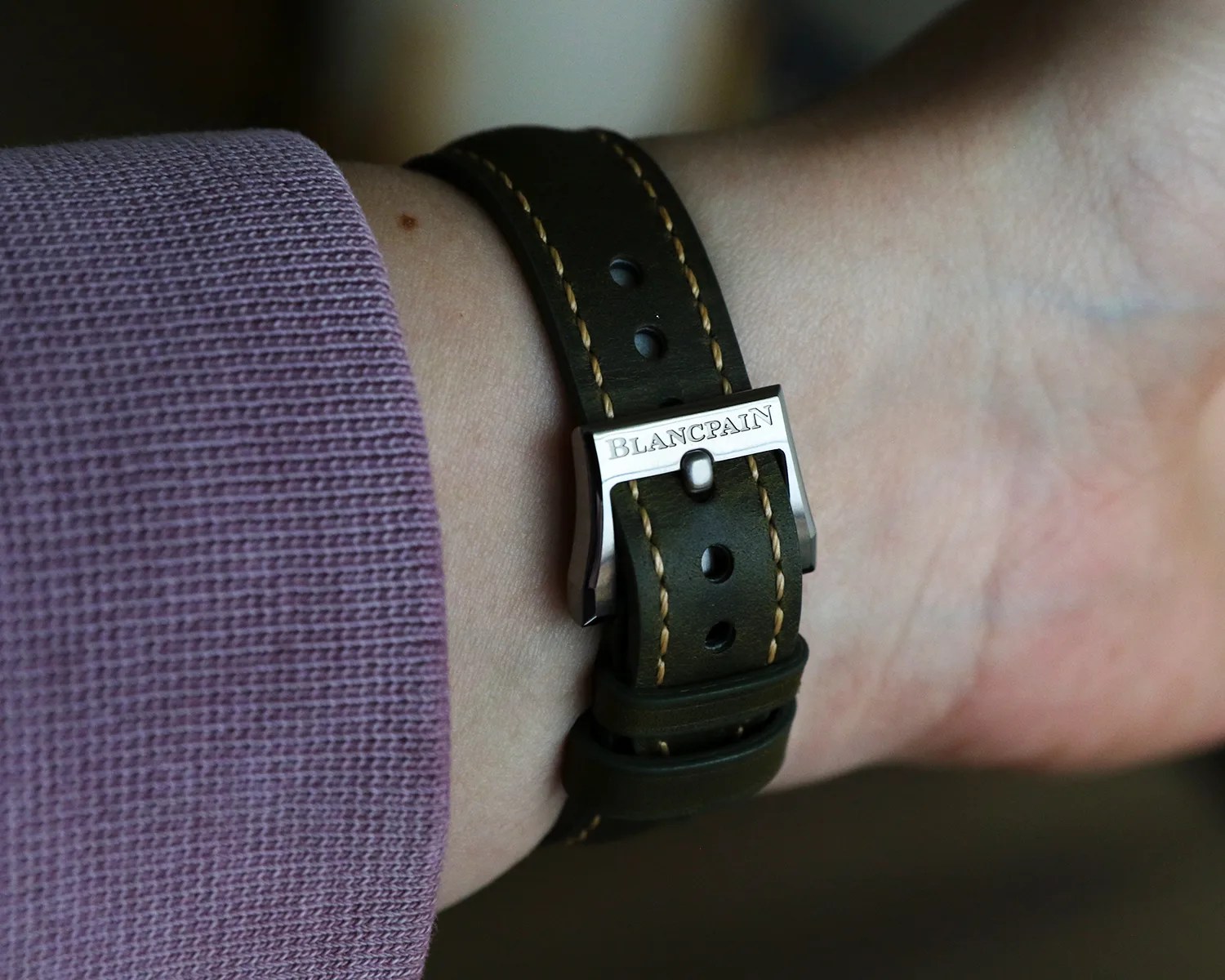 the buckle seen on a blancpain watch strapped on a wrist