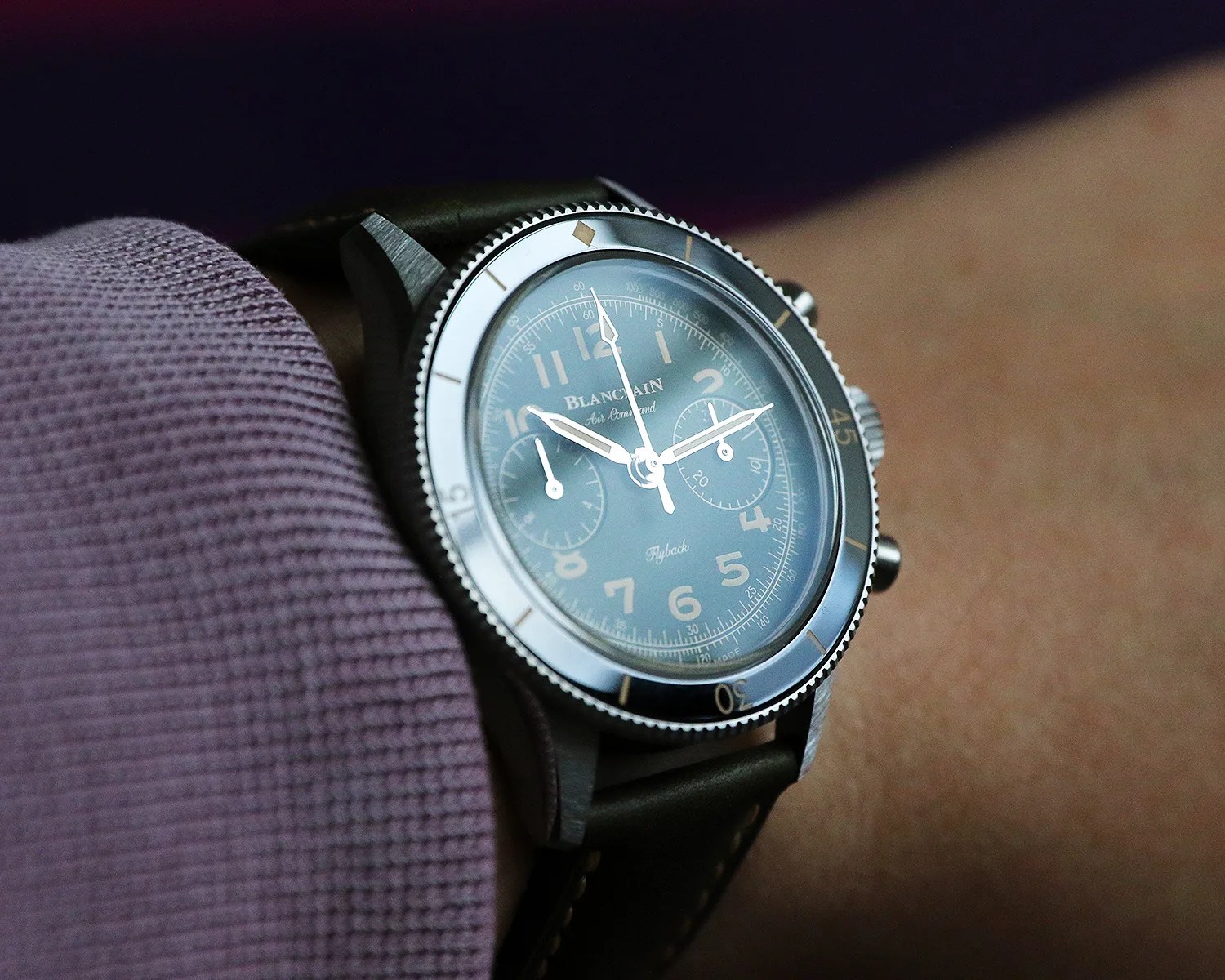 a blancpain chronograph watch on a wrist reflects light