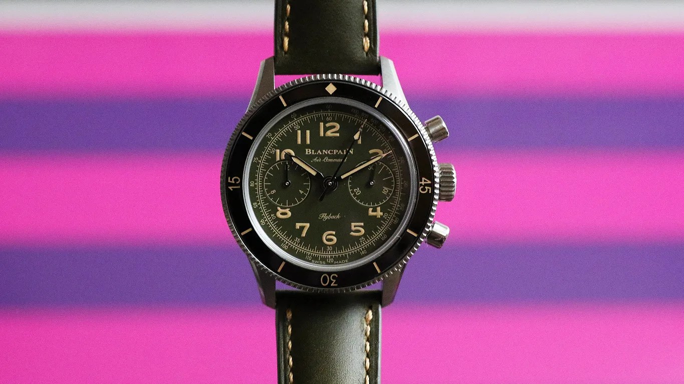 a blancpain military chronograph watch against a colorful striped background