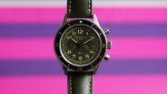 a blancpain military chronograph watch against a colorful striped background