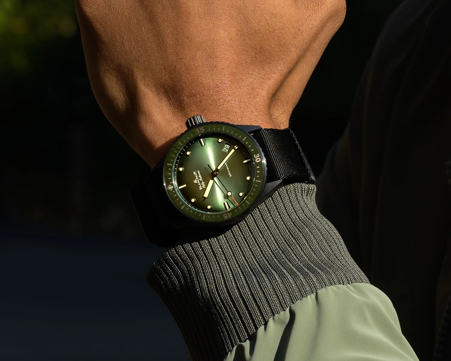 a blancpain fifty fathoms ceramic dive watch on a mans wrist