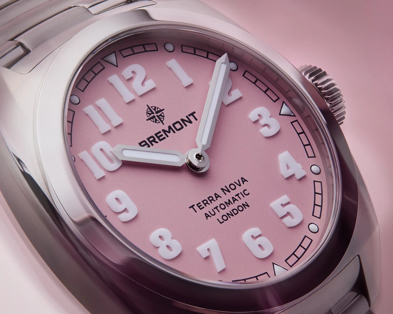 a closeup of a pink bremont field watch dial