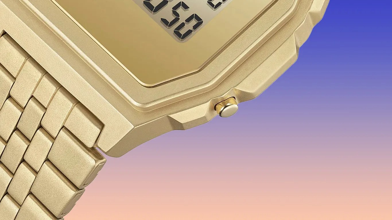 a gold casio x apc watch against a gradient background