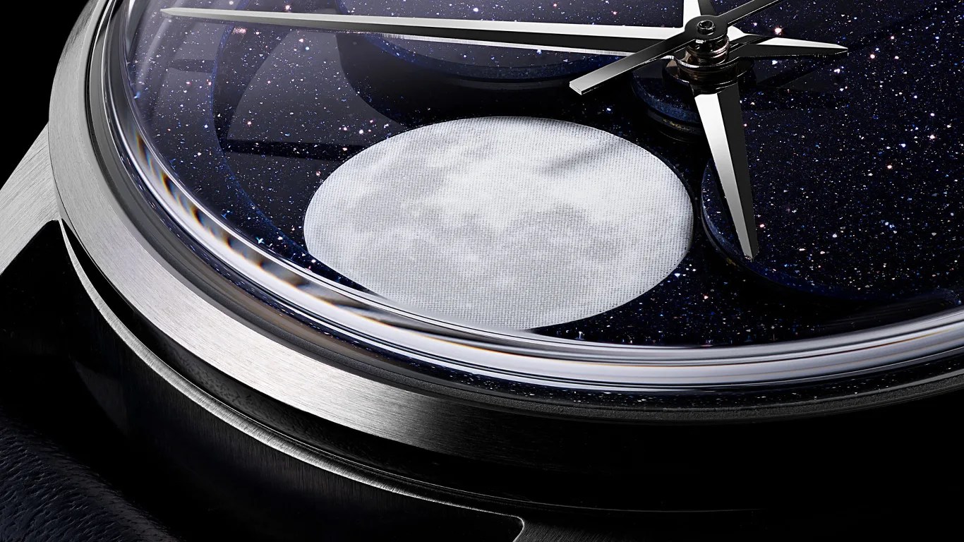 a closeup on the dial of a christopher ward moonphase watch showing the moon