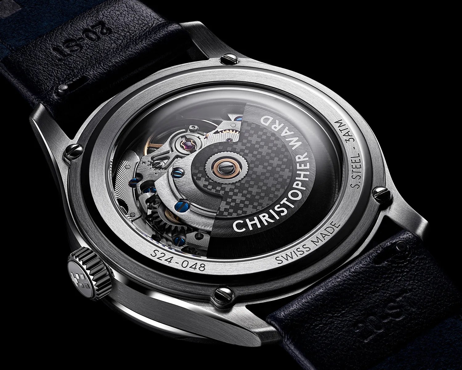 the automatic movement seen through a display caseback on a christopher ward moonphase watch