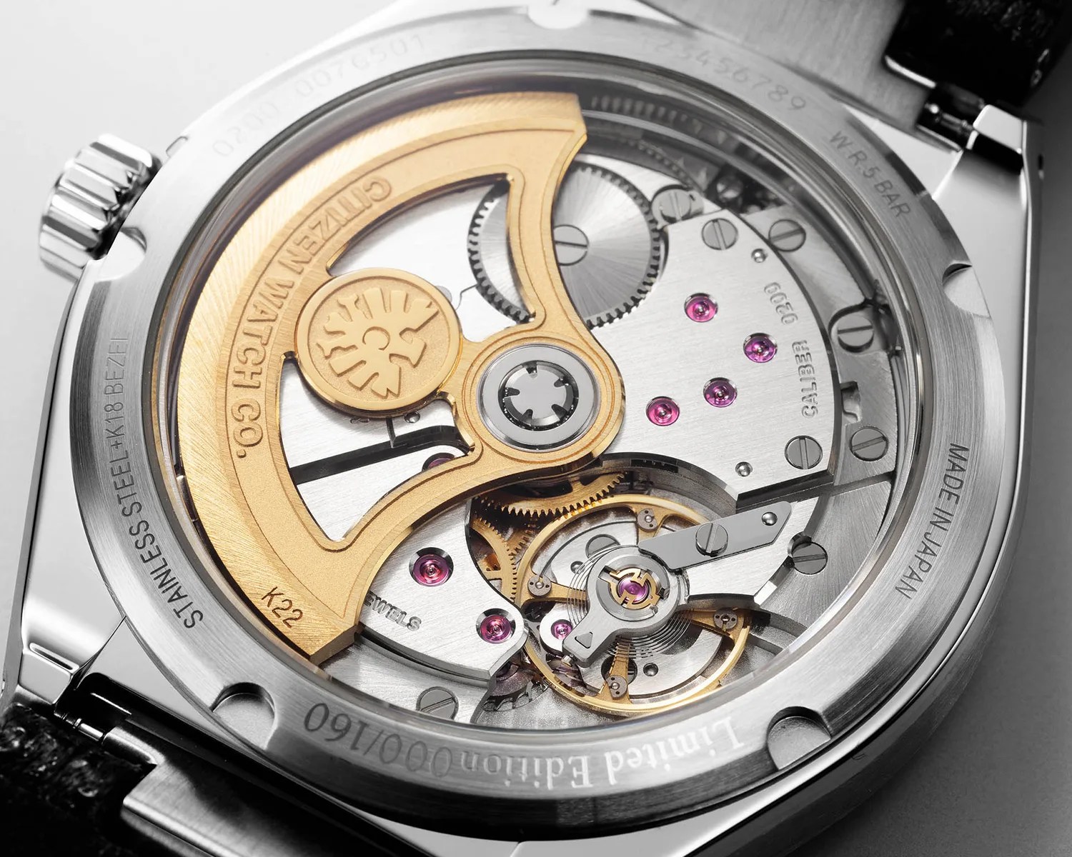 a closeup of a citizen mechanical watch movement seen through a sapphire caseback