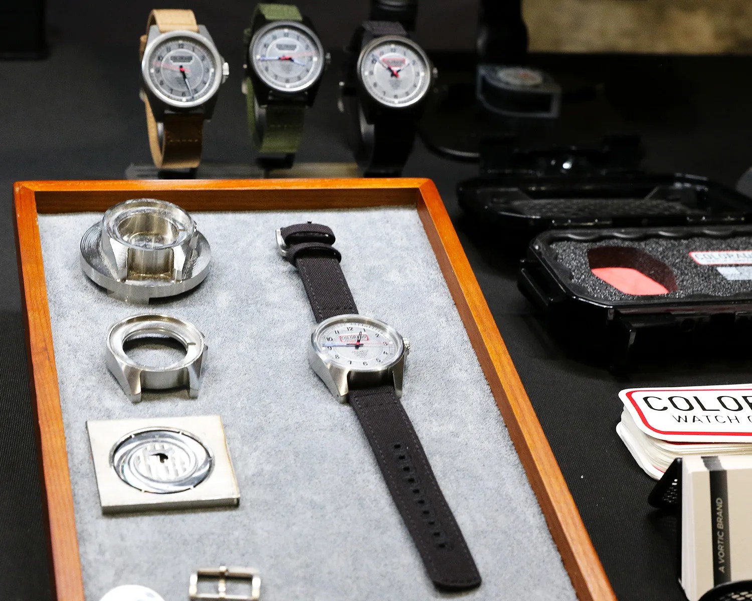 a colorado watch on display next to some machined watch parts
