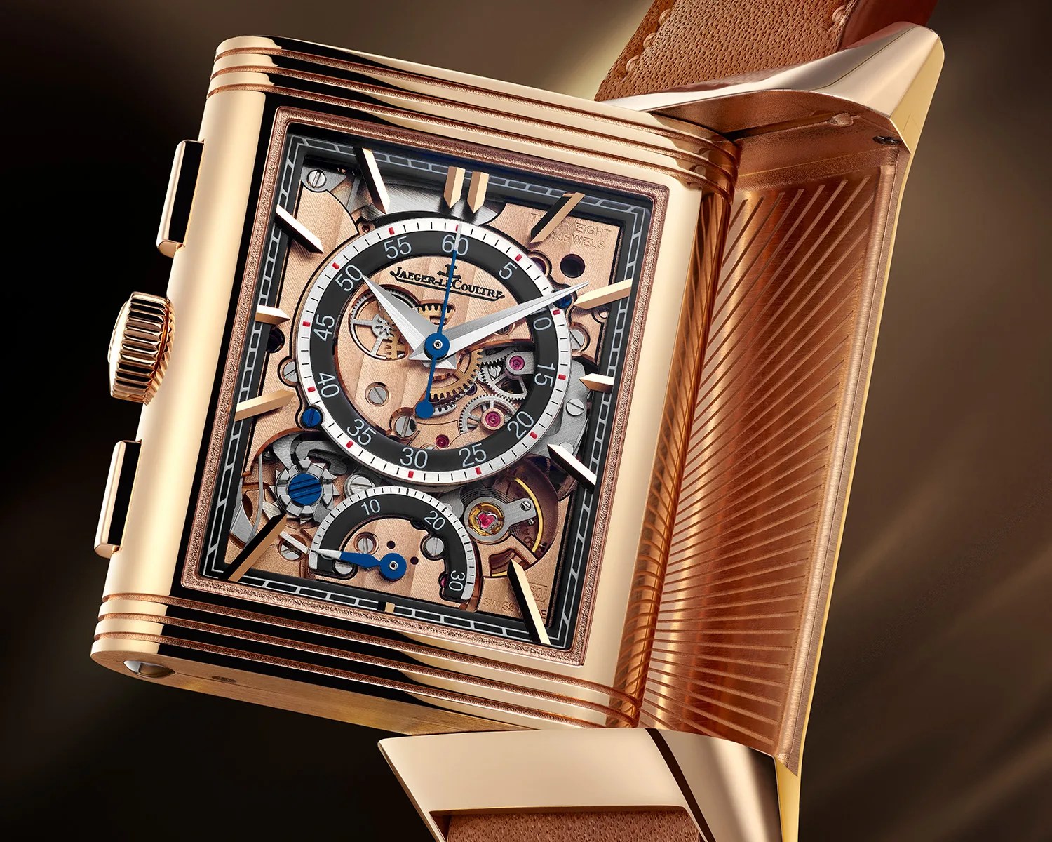 the complicated dial of a gold jaeger lecoultre reverso chronograph dress watch
