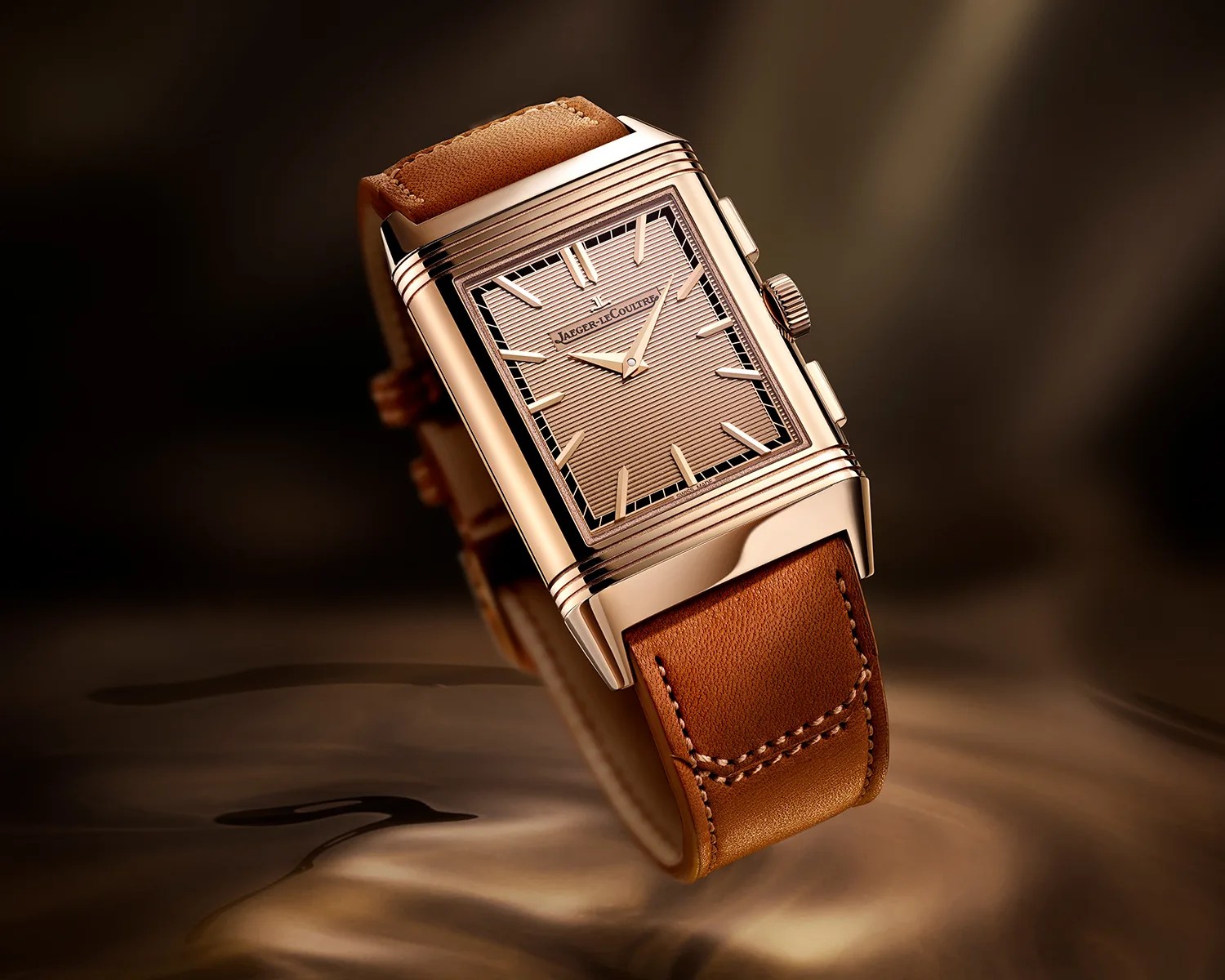 a gold jaeger lecoultre reverso dress watch in a golden setting