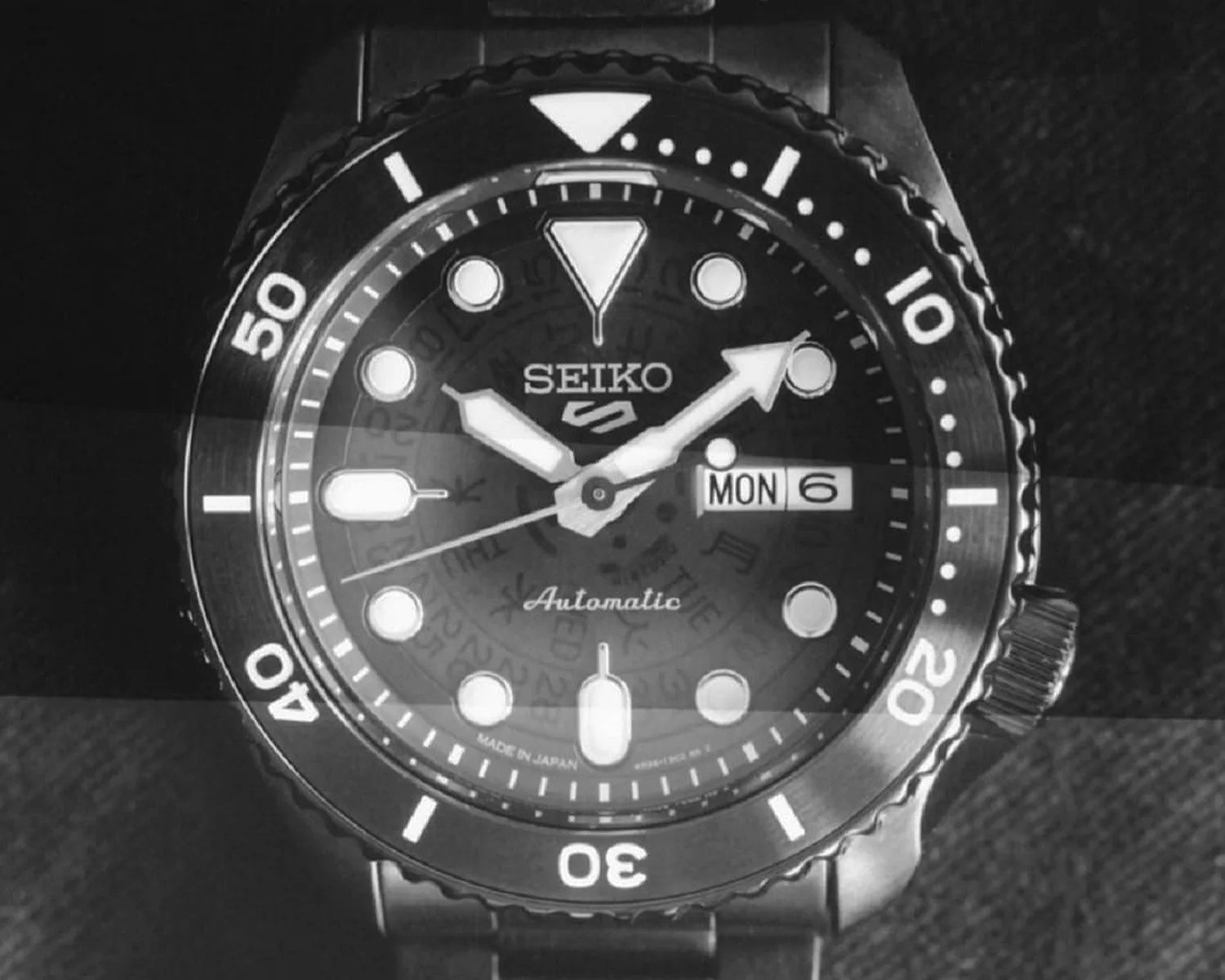 a black seiko 5 sports beams watch