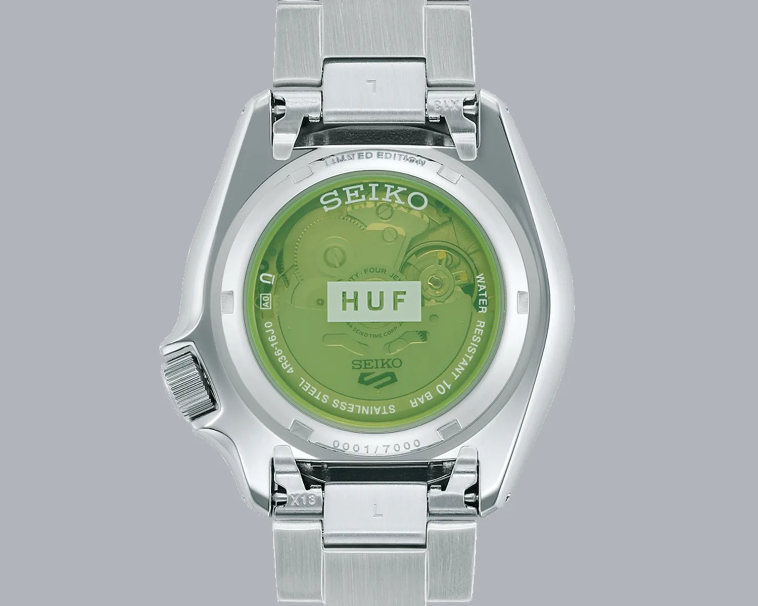 the green crystal caseback of a seiko x huf watch