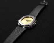 a serica dress watch on a black table cloth