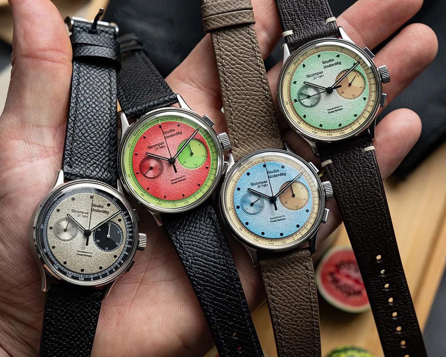 four a studio underd0g watches held in a hand