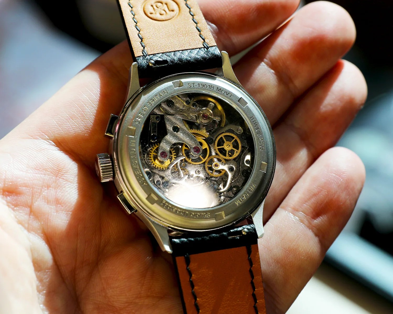 the mechanical movement of a studio underd0g watch viewed through a display caseback