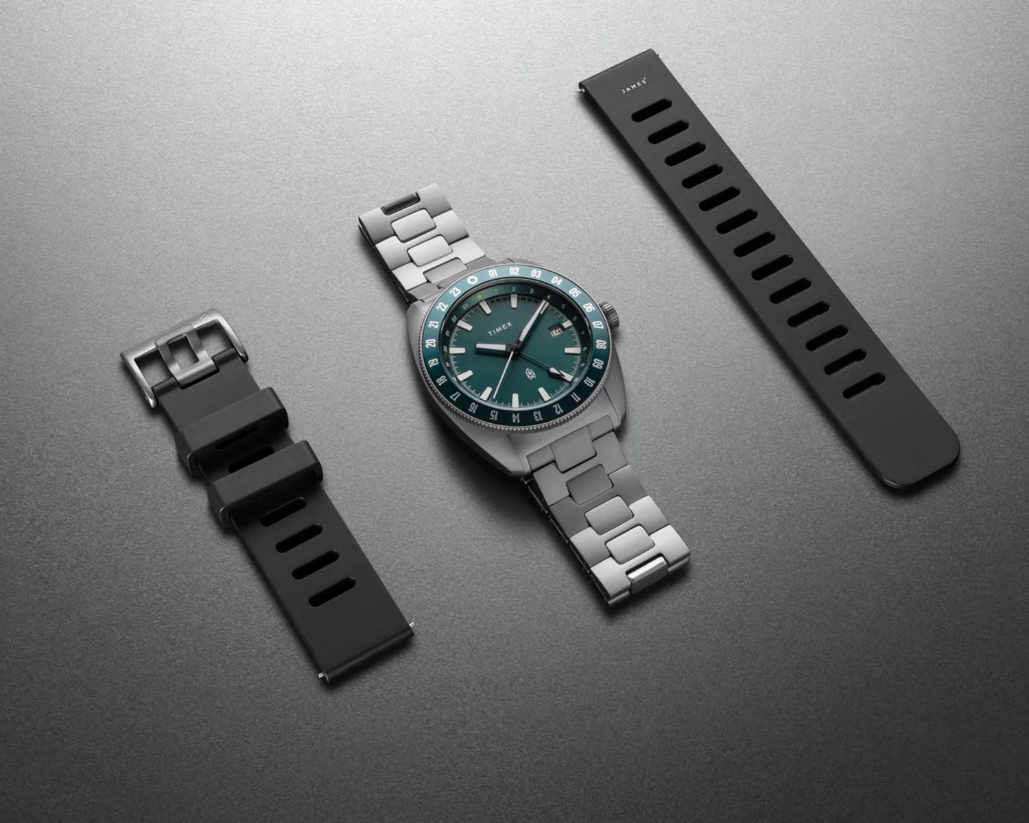 a timex x the james brand gmt watch next to a black strap