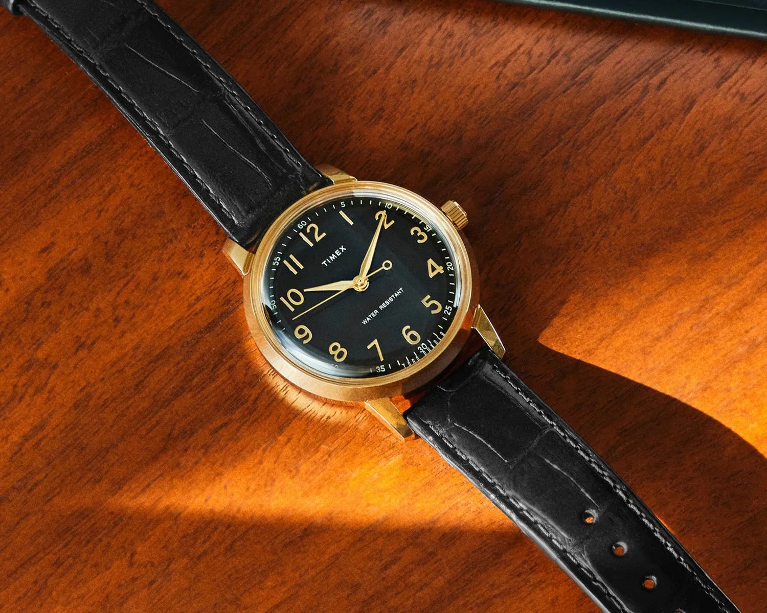 a todd snyder x timex marlin watch on a wooden table