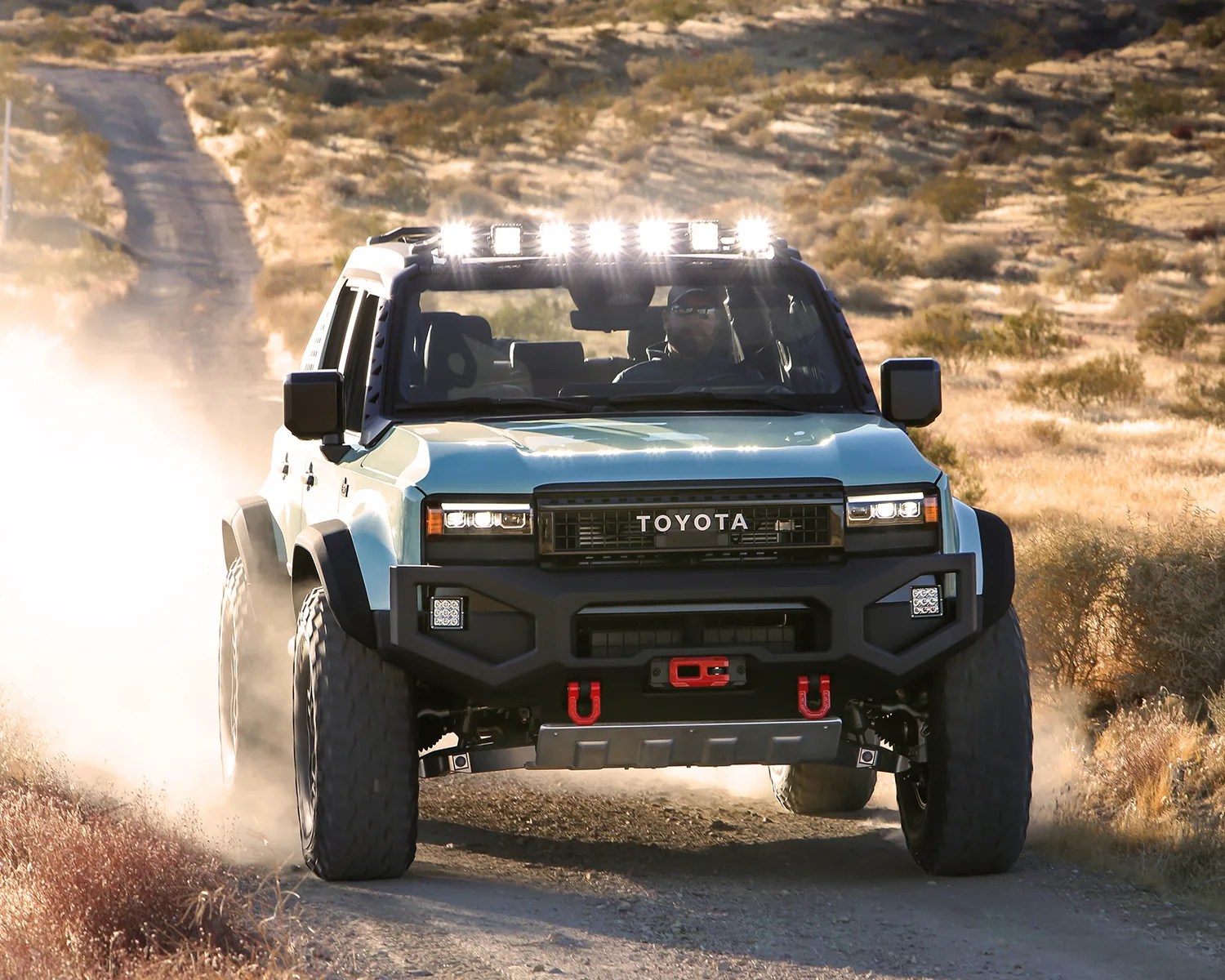 the toyota land cruiser rox concept suv drives down a dirt road