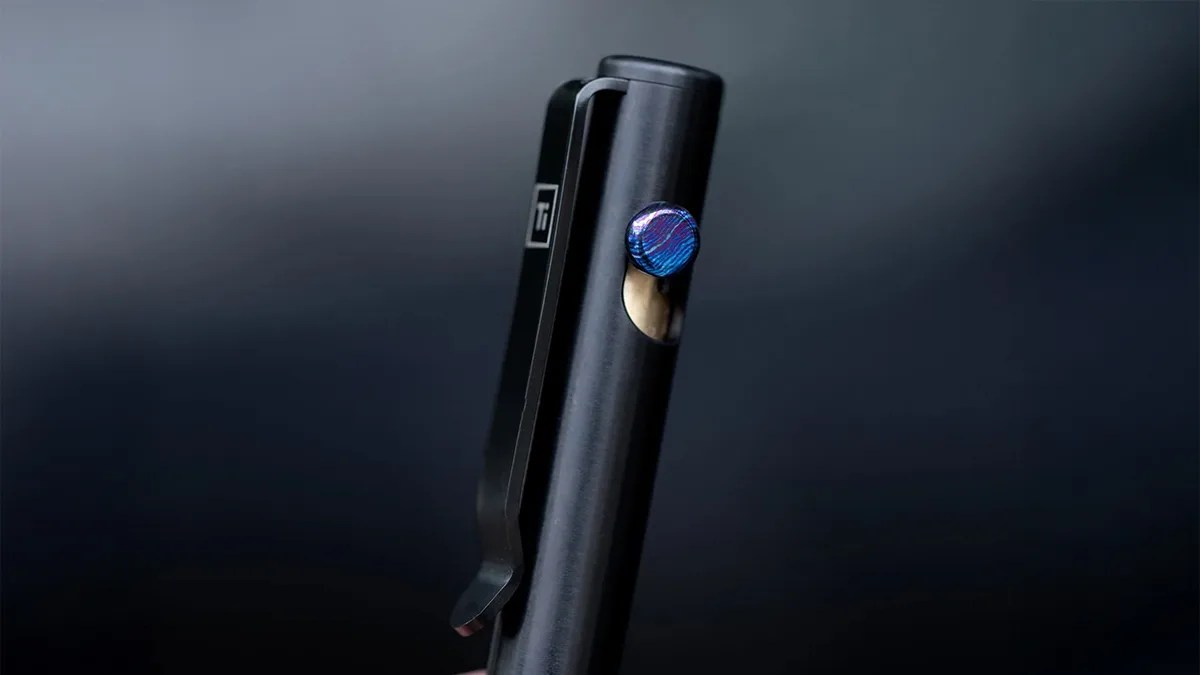 Big Idea Design bolt-action pen on black blurry background