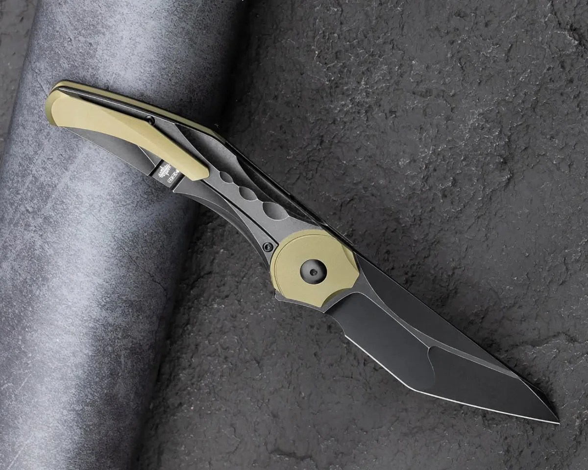 Bestech Excentric knife open on stone and metal background