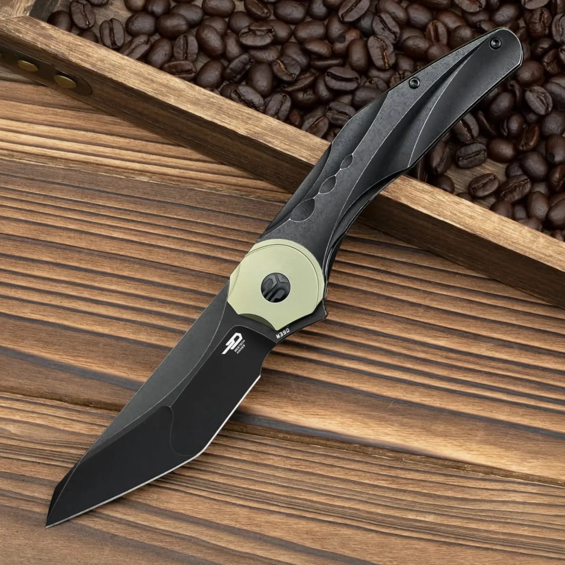Bestech Excentric knife open on wood counter with coffee beans