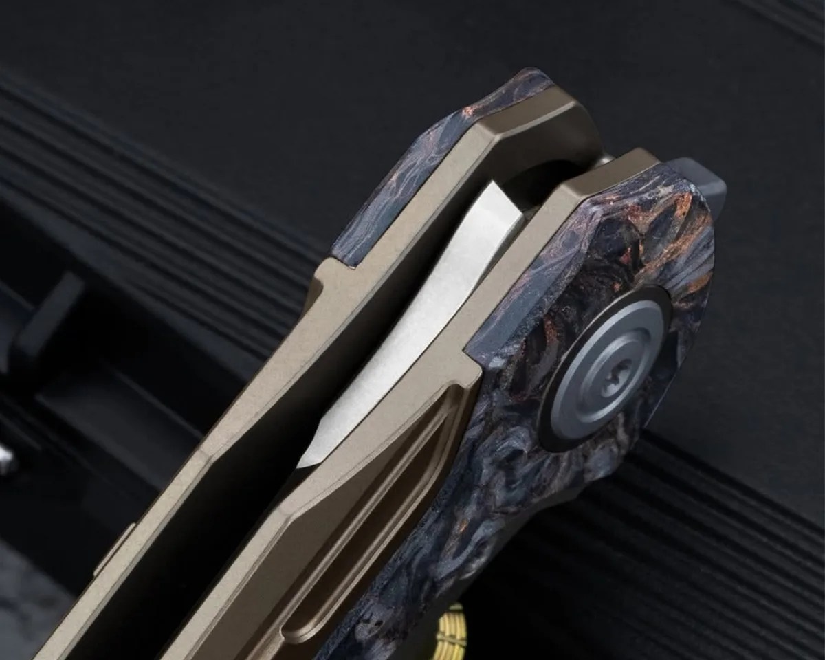 Closeup of Bestech Prydwen knife pivot on black background
