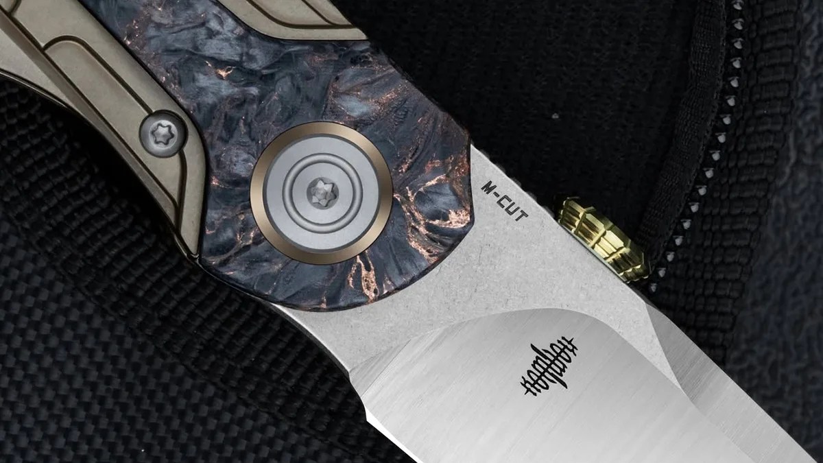 Closeup of Bestech Prydwen knife pivot on black fabric background