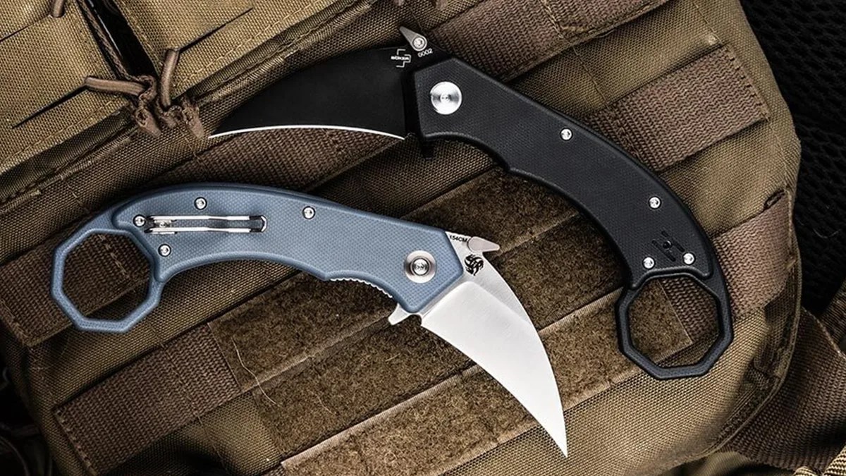 Two Böker Hel Karambits sitting on tactical pack