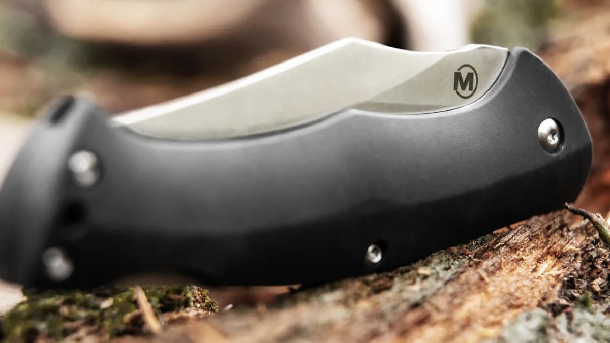 Close-up shot of Boker Magnum Echidna knife on forest floor