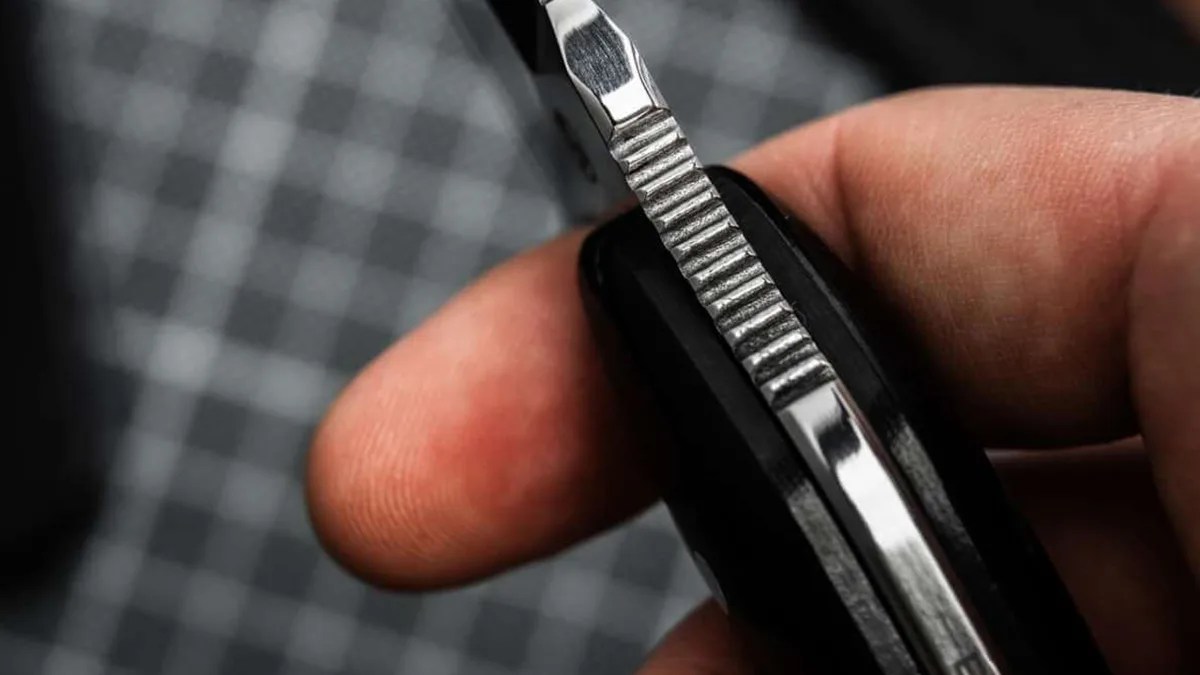 Böker Magnum Enki knife closeup of blade spine jimping held in hand
