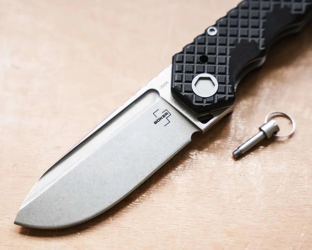 Böker Plus Hermod Folder with pin pulled out on tan countertop